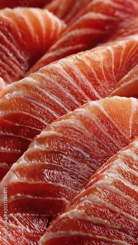 Fresh salmon slices on display at a seafood market in the city during a busy afternoon