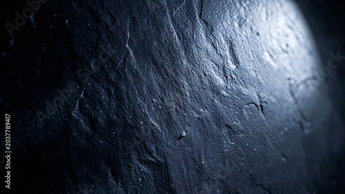Stone texture surface with dramatic high contrast illumination and deep shadows