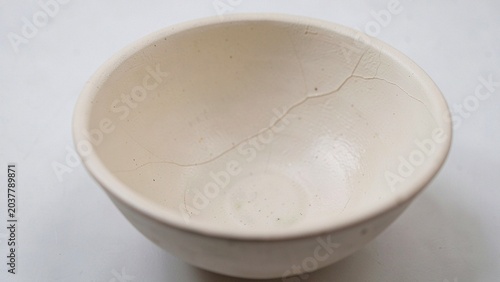 Earthenware bowl with fine crack detail showcasing rustic pottery texture