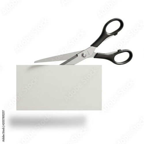 Scissors cutting a blank white business card isolated on white background