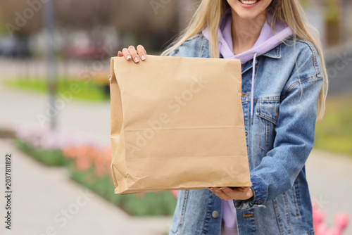 Young woman with paper bag ...