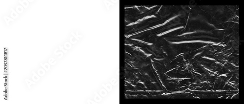 Cuadro en lienzo Crumpled plastic wrap texture on black background, wrinkled cellophane film over