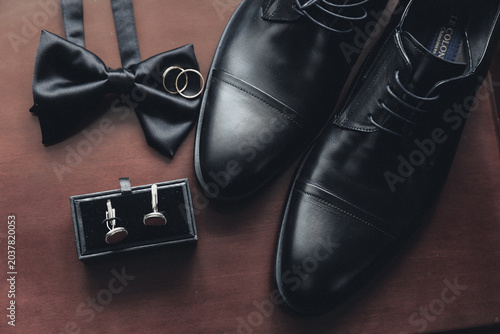 Fotografía Black bow tie rests beside polished dress shoes