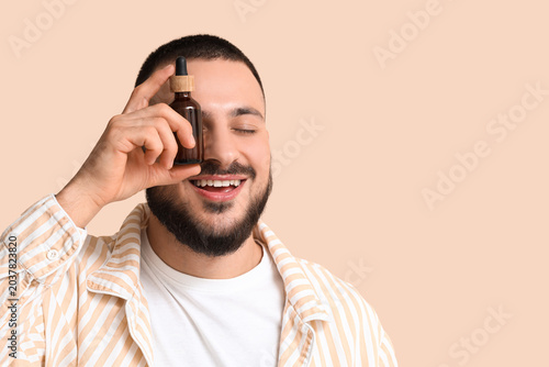 Happy young man with bottle...