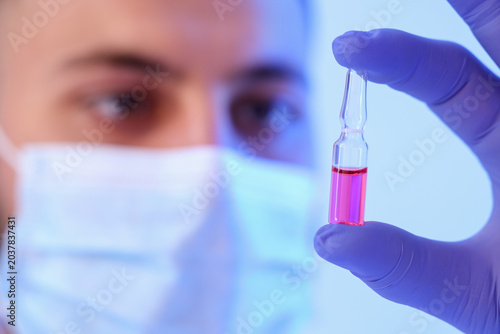 Male scientist with ampoule...