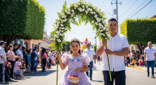 Young girl and man carrying a floral arch during a religious procession.