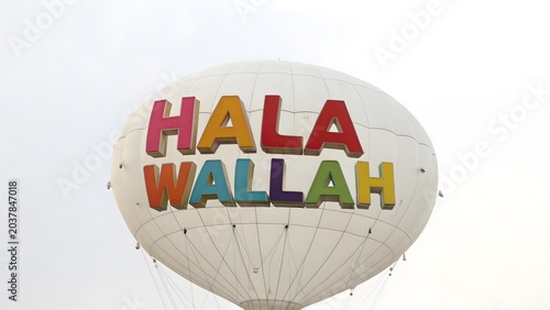 White hot air balloon with colorful hala wallah text