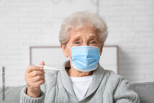 Elderly woman in medical ma...