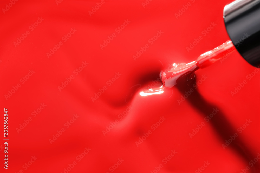 Obraz premium Red nail polish and brush as background, above view. Space for text