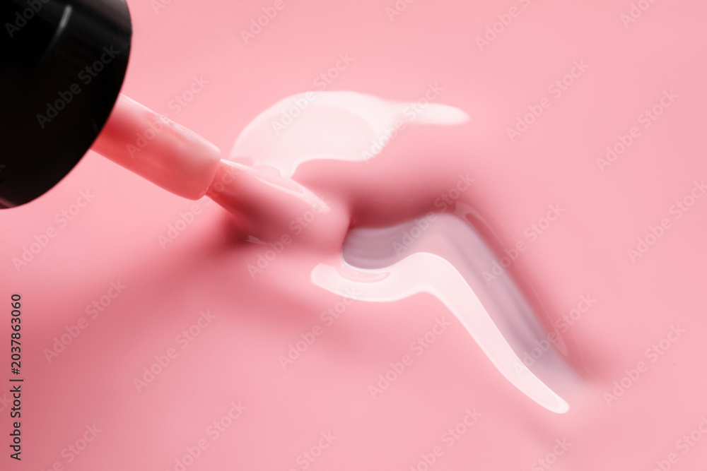 Obraz premium Pink nail polish and brush as background, above view. Space for text