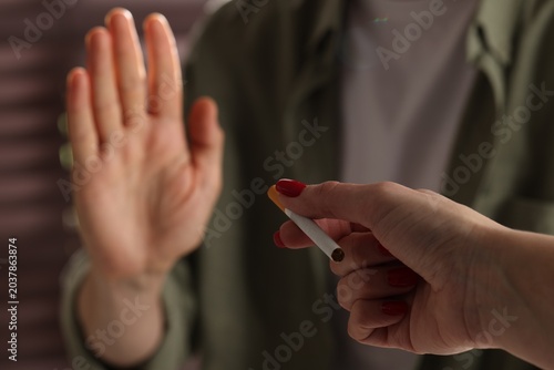 Konstfotografi Man refusing cigarette from woman indoors, selective focus