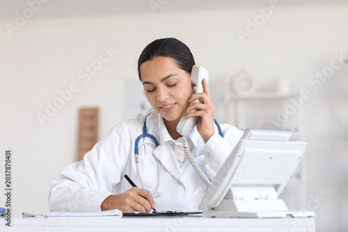 Young female doctor talking...