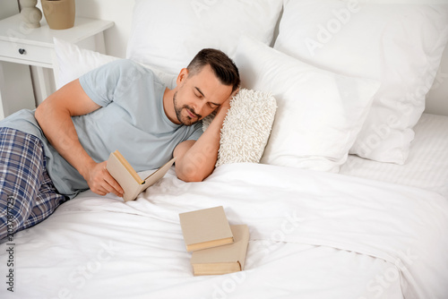 Handsome man with book slee...