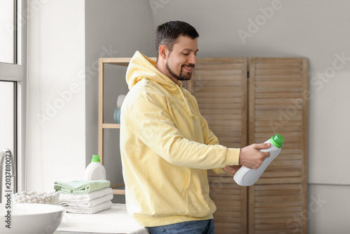 Young man with laundry dete...