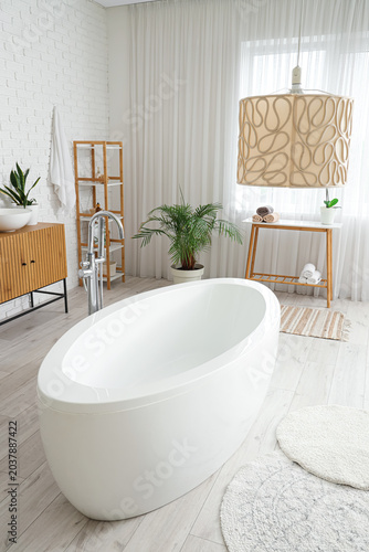 Modern bathroom with bathtu...