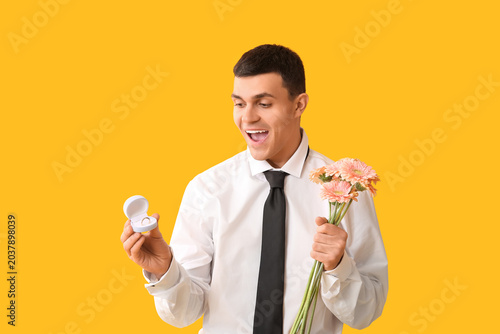 Handsome man with flowers a...