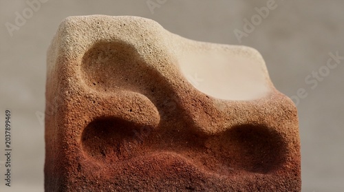 Tapety artystyczne Textured abstract stone with smooth concave shapes and gradient color