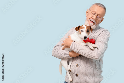 Senior man with cute dog an...
