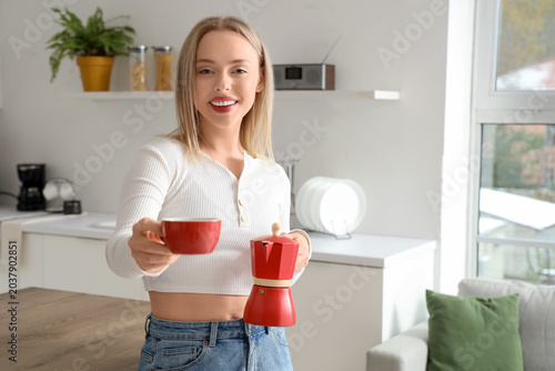 Pretty young woman with cup...
