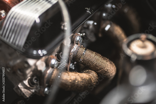 Fotografía Close-up of a vintage car engine's exhaust manifold with heat wrap