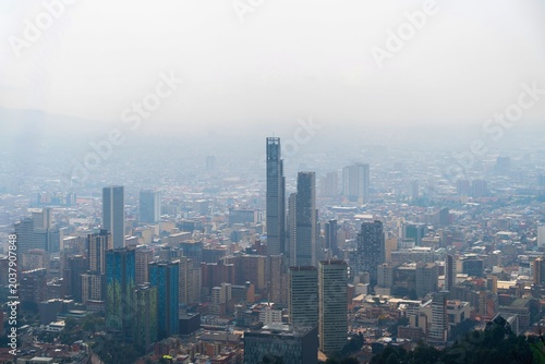 Aerial view of Bogotá cityscape under dramatic cloudy sky, Colombia