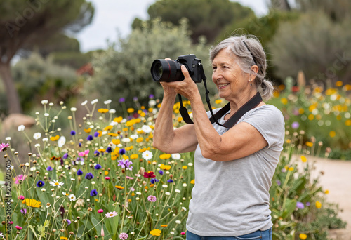 Retired Woman Photographing Wildflowers in French Riviera Park