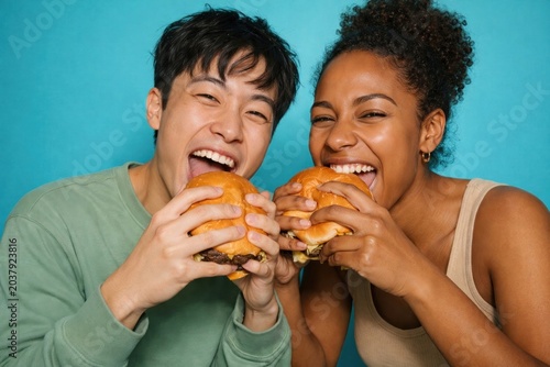 Joyful friends enjoying burgers