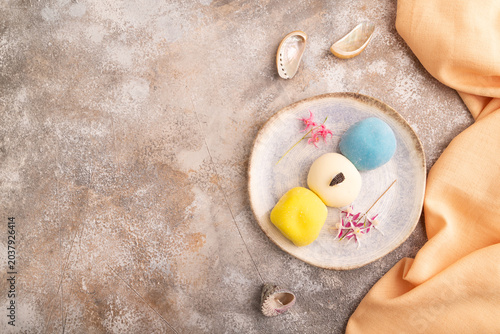 Japanese Mochi Cakes on brown concrete, orange textile, top view, flat lay, copy space