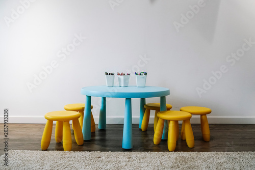 Colorful Kids Activity Table and Stools in Modern Playroom Interior
