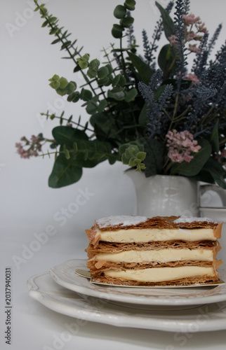 Elegant Vanilla Mille-Feuille Dessert with Floral Background