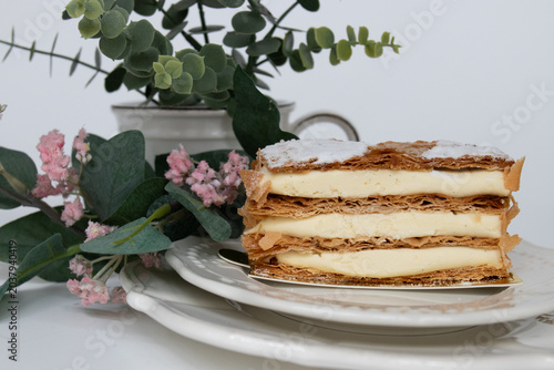 Elegant Vanilla Mille-Feuille Dessert with Floral Background