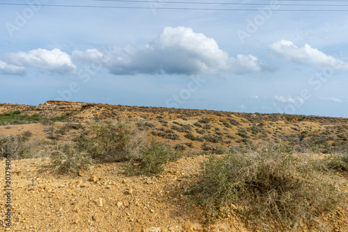 Photos Arid scrubland landscape under dramatic cloudy sky