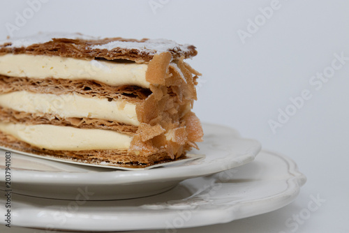 Elegant Vanilla Mille-Feuille Dessert with Floral Background