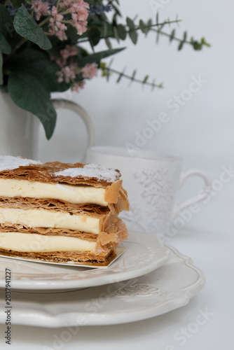 Elegant Vanilla Mille-Feuille Dessert with Floral Background
