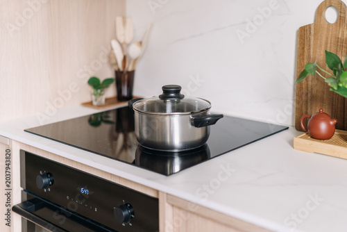 Tableau sur toile Modern kitchen with black induction hob and built-in oven