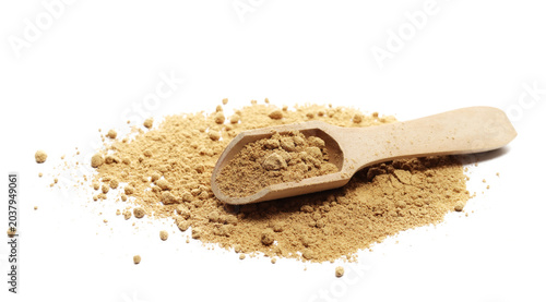 Ginger powder pile with wooden spoon isolated on white background