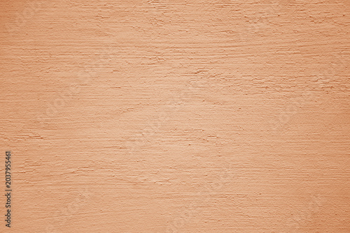 Coral red pink stucco wall texture, peach fuzz color background. Abstract artistic backdrop for design. Salmon color, pastel orange plaster, exterior wall building texture pattern.
