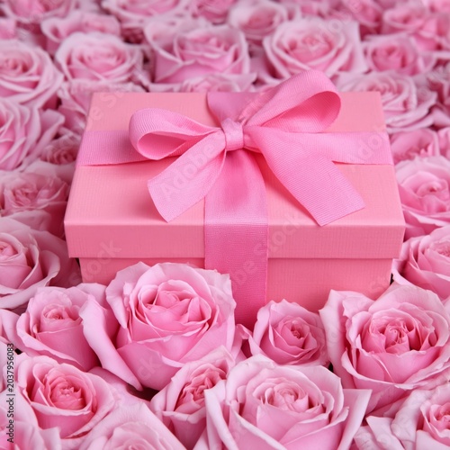 Decorative Pink Roses in a Gift Box on a White Surface With Ribbon and Fabric