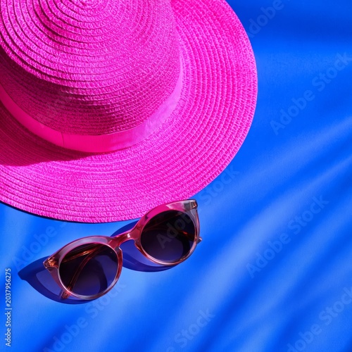 Bright Pink Hat and Sunglasses on a Blue Background Ready for Summer Fun
