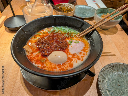 A bowl of spicy ramen soup