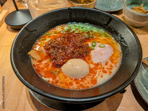A bowl of spicy ramen soup