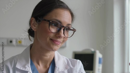 Female doctor wearing glasses speaking in consultation