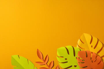 Summer tropical paper leaves on bright orange background with vibrant colors and space for copy