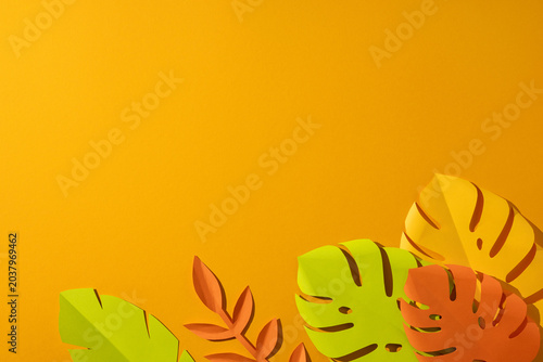 Konstfotografi Summer tropical paper leaves on bright orange background with vibrant colors and