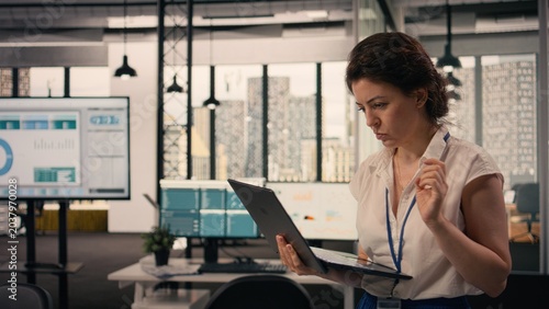 Canvas-taulu Pacing the floor, agitated nervous woman, repetitive fidgeting, back and forth, nervousness at work, task management, modern office, multinational company, anxious physical expression