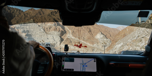Schilderij op canvas GPS maps navigator in the car with view of mountains on a road trip in Oman