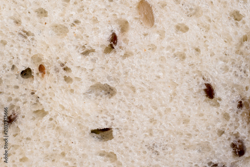 Photos Macro shot of soft multigrain white bread crumb with visible seeds and textured air pockets