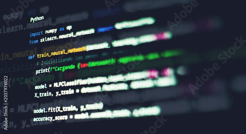 Photos Python machine learning code with neural network syntax displayed on a dark moni