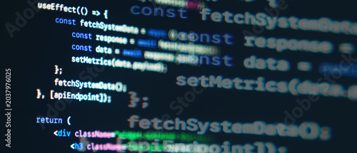 Photos JavaScript React frontend code with fetch API syntax displayed on a dark monitor