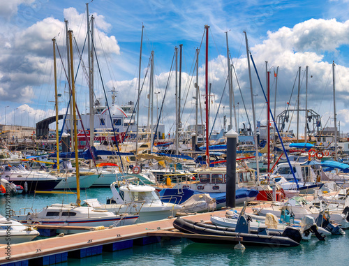 Recently arrived ferry at Corralejo harbor surrounded by yachts and sailing boats on Fuerteventura